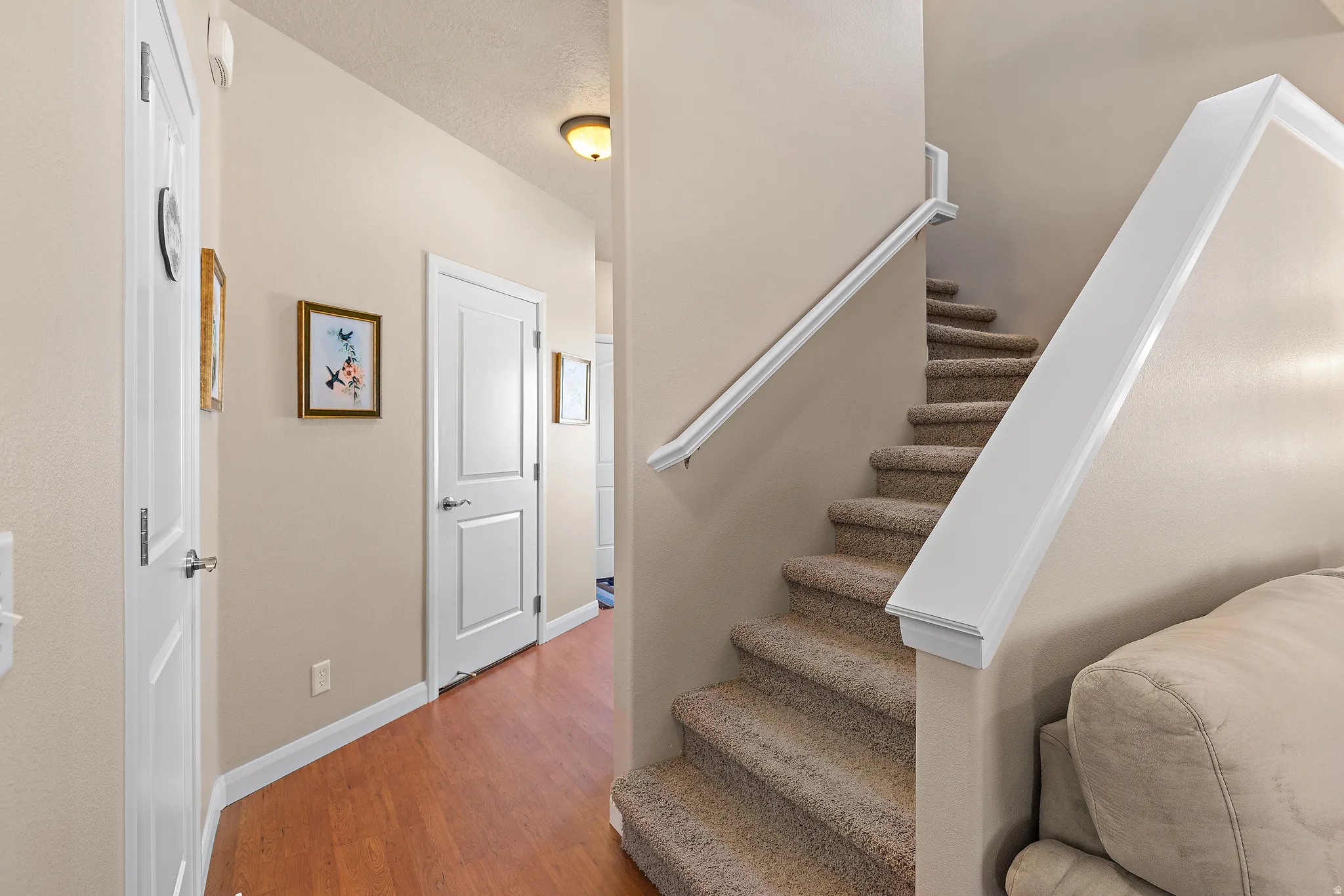 Staircase featuring wood finished floors and baseboards