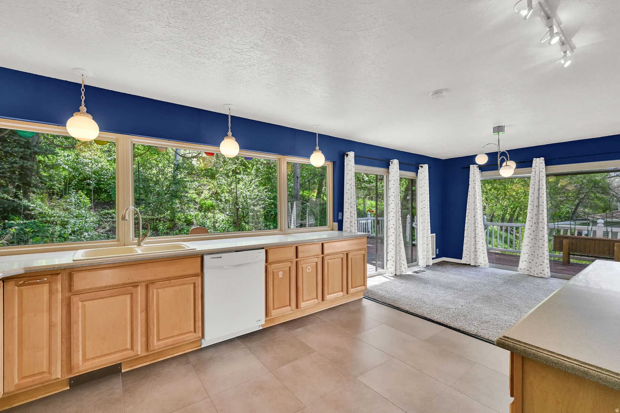 Open and spacious kitchen with huge windows to gorgeous back yard view