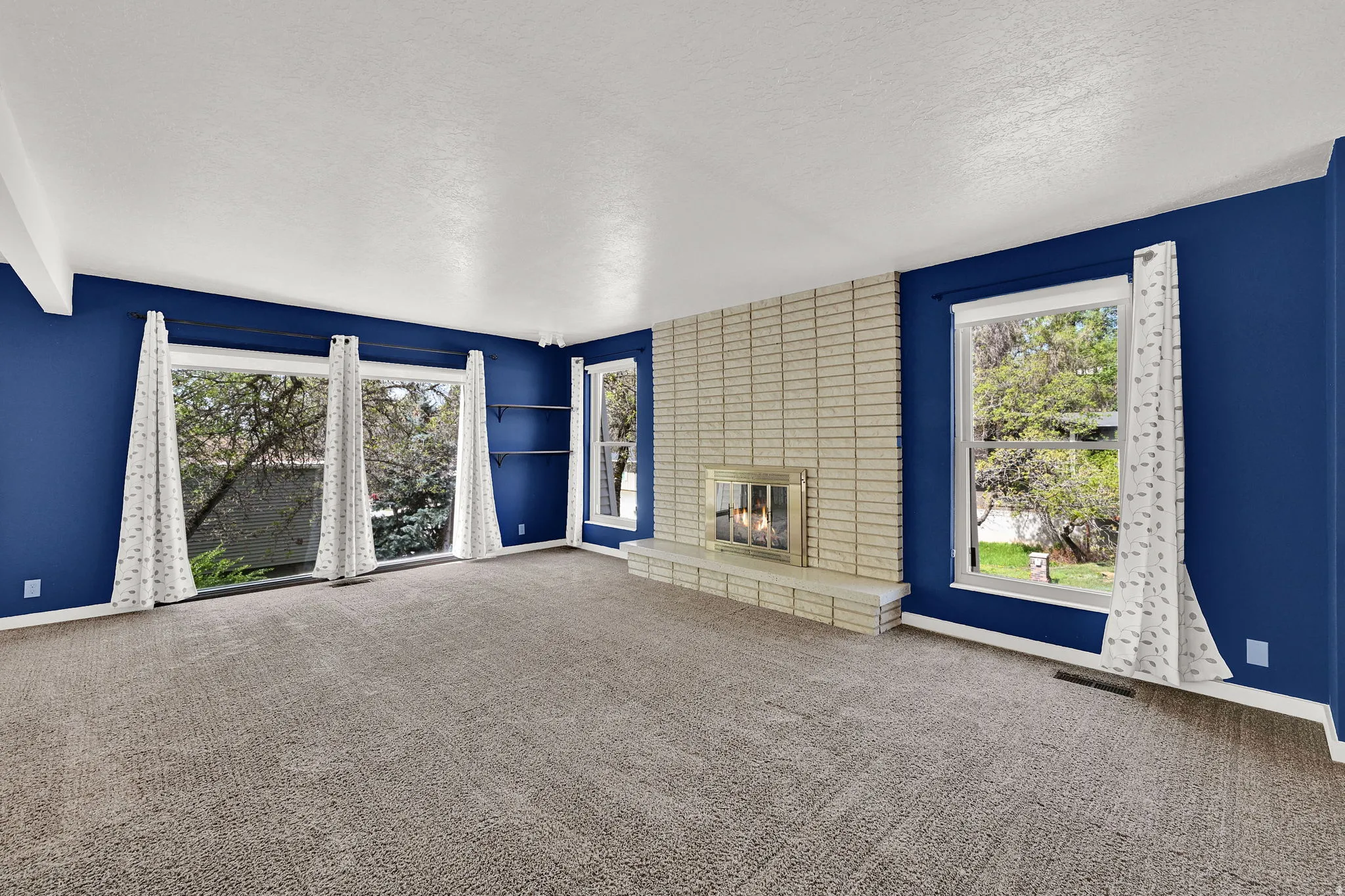 Multiple oversized windows bathe the living room with light