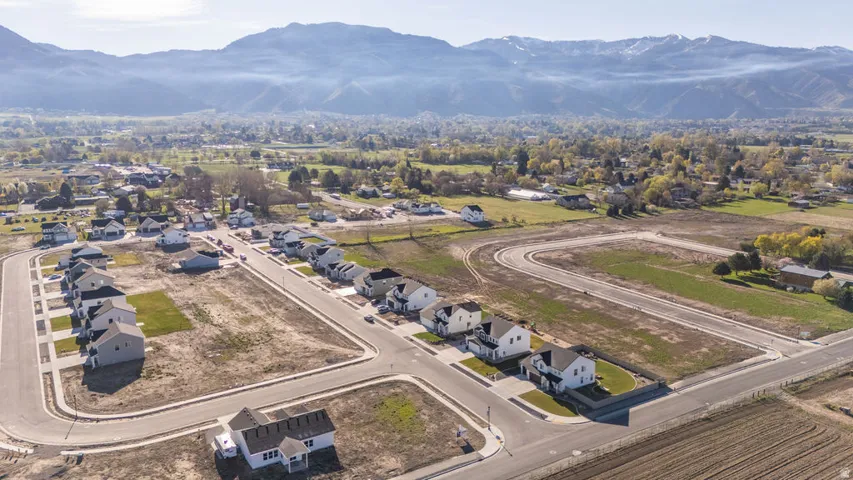 View of property location with mountains and nearby suburban area
