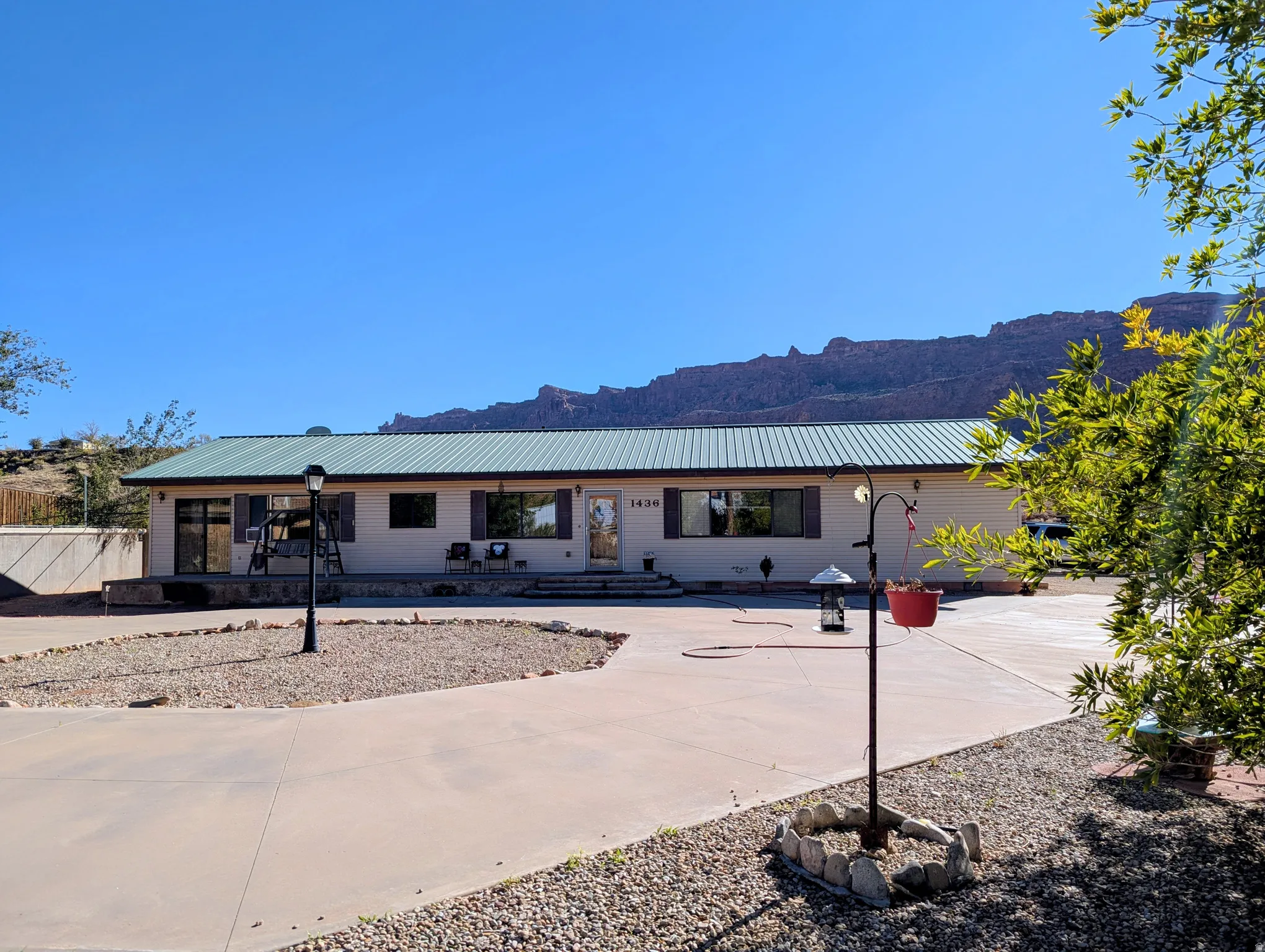 Single story home featuring a metal roof and a mountain view