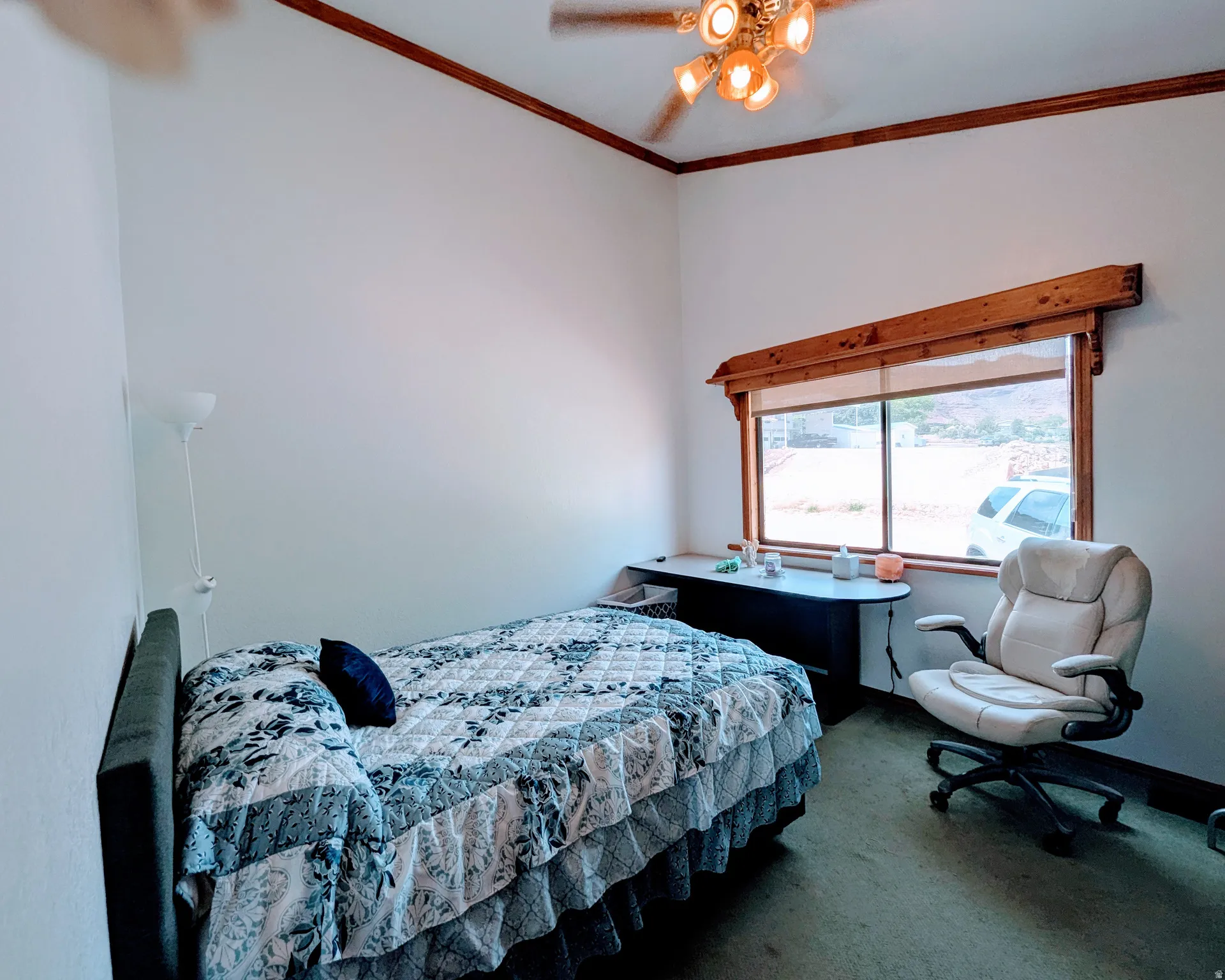 Bedroom with carpet, ornamental molding, and ceiling fan