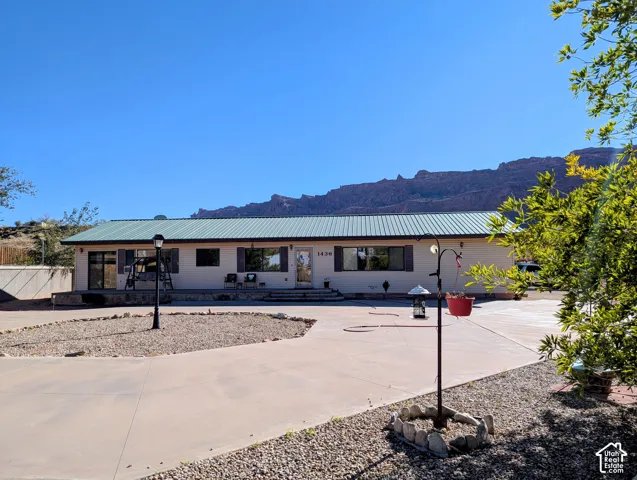 Single story home featuring a metal roof and a mountain view