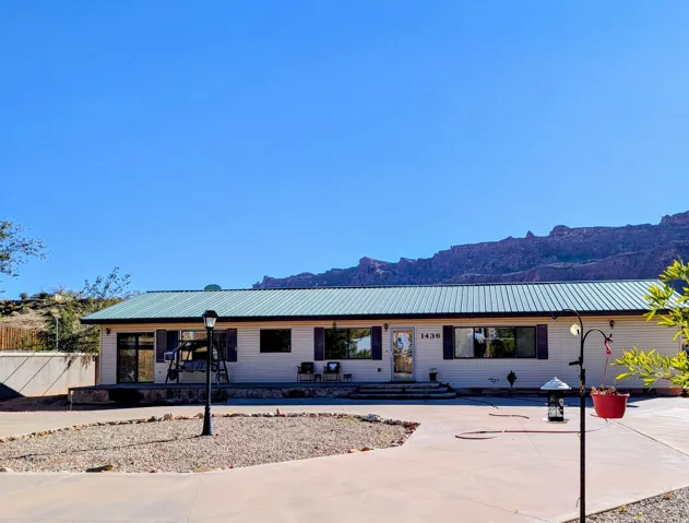 Single story home with a mountain view and a metal roof