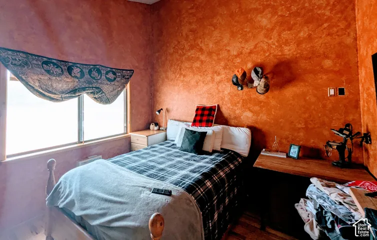 Bedroom with dark wood-type flooring