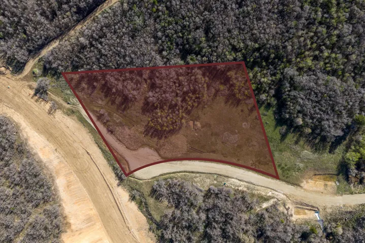 Aerial view of property and surrounding area featuring property boundaries highlighted