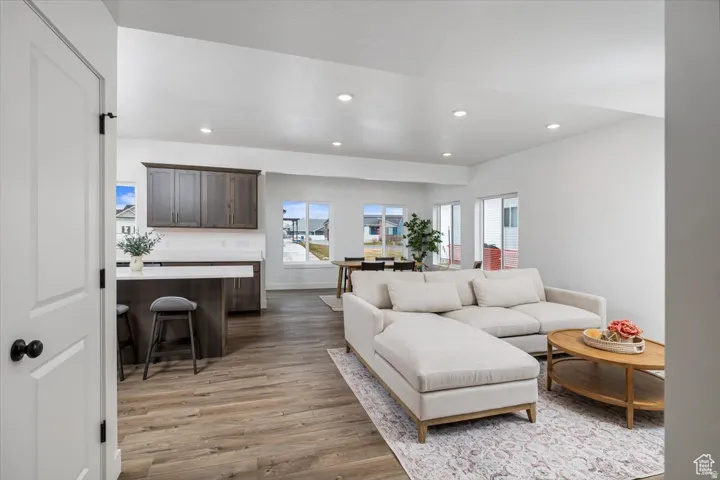 Living area featuring light wood-style floors and recessed lighting