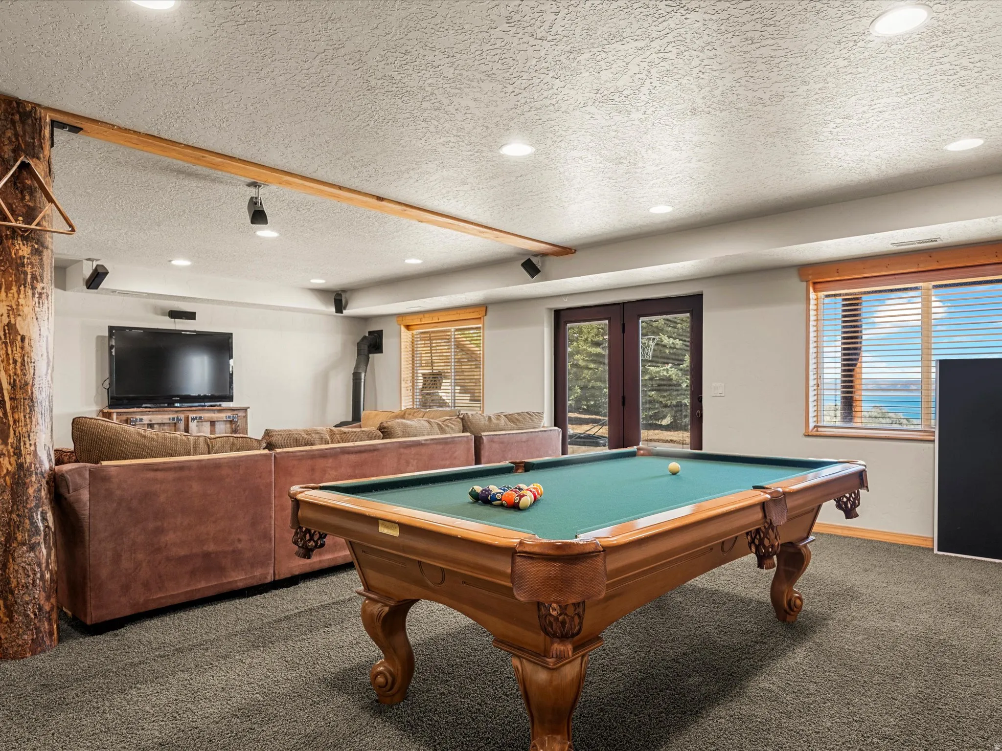 Game room featuring carpet flooring, french doors, a textured ceiling, pool table, and recessed lighting