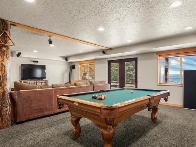 Game room featuring carpet flooring, french doors, a textured ceiling, pool table, and recessed lighting