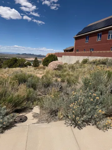 View of side of property with a mountain view and brick siding