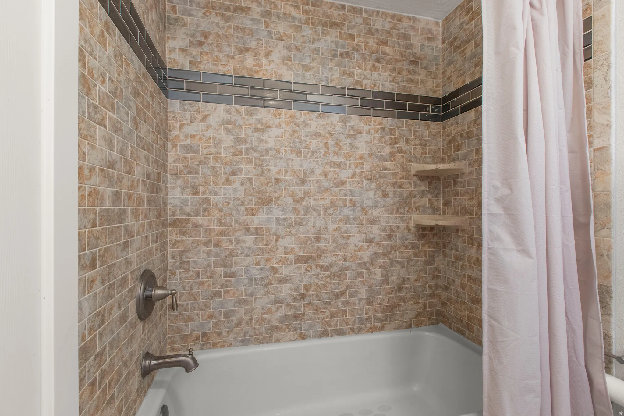 Full bath featuring shower / tub combo with curtain