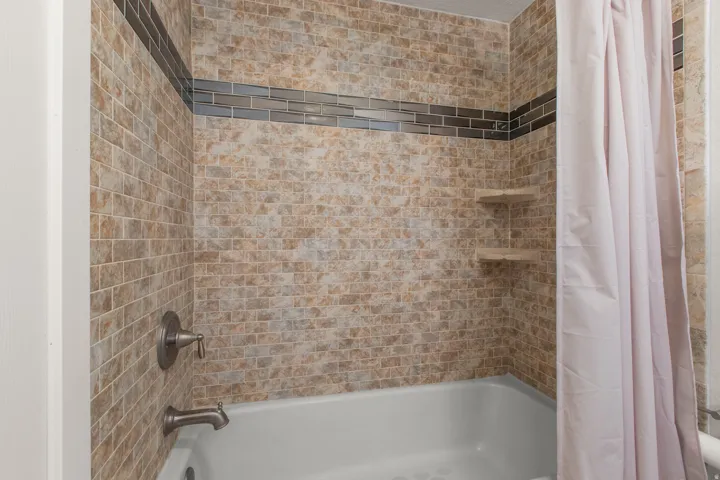 Full bath featuring shower / tub combo with curtain