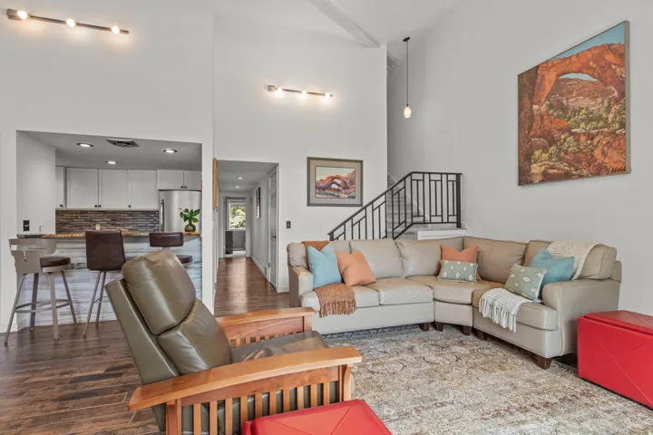 Living area featuring wood finished floors and a high ceiling