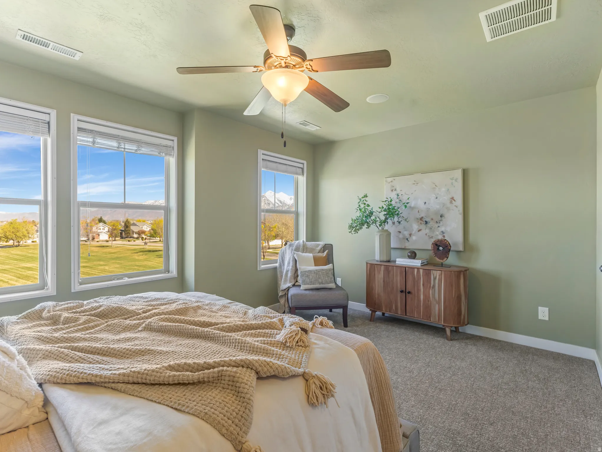 Primary Bedroom with carpet flooring and ceiling fan