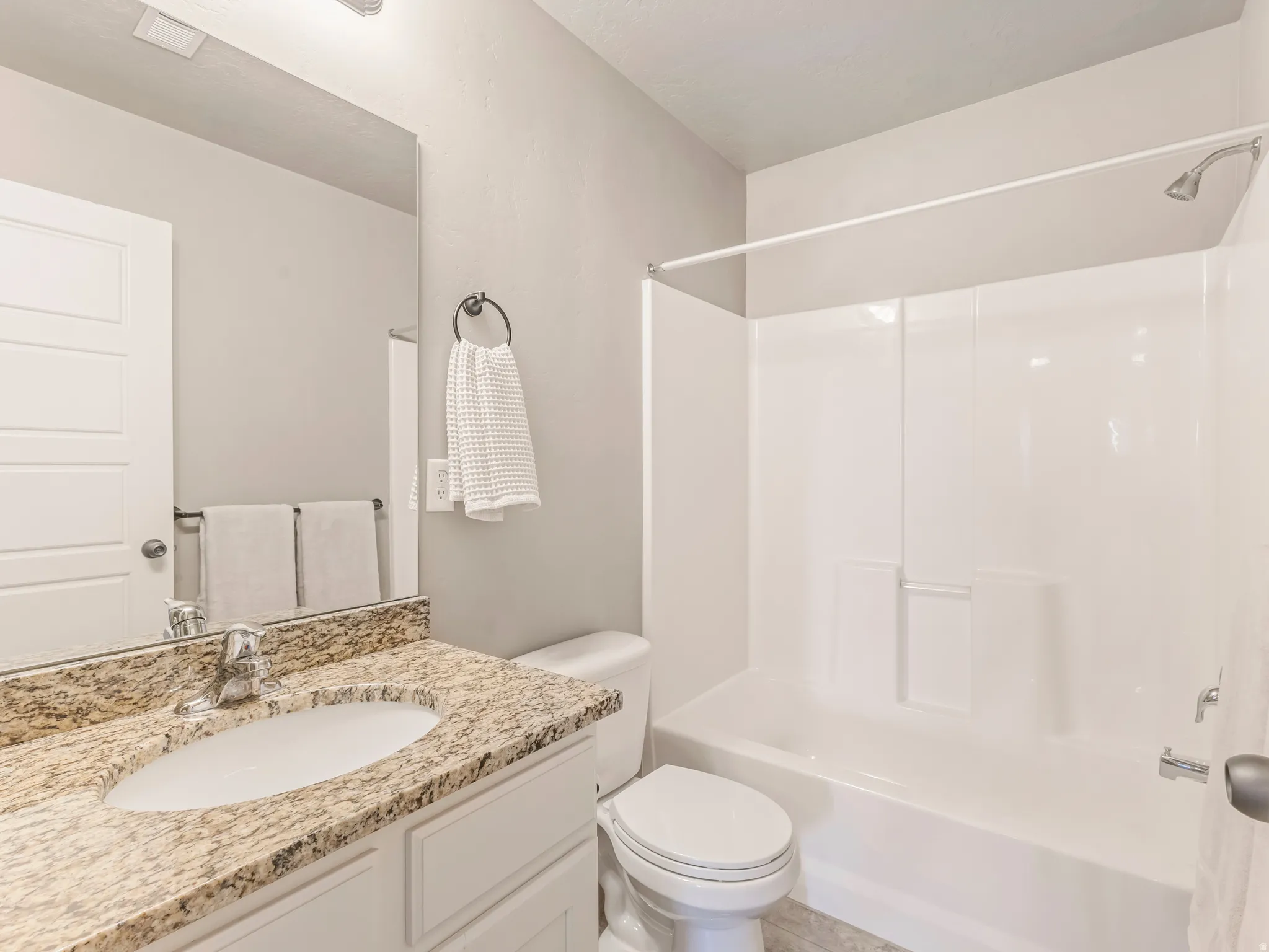 Full bath featuring vanity and bathing tub / shower combination