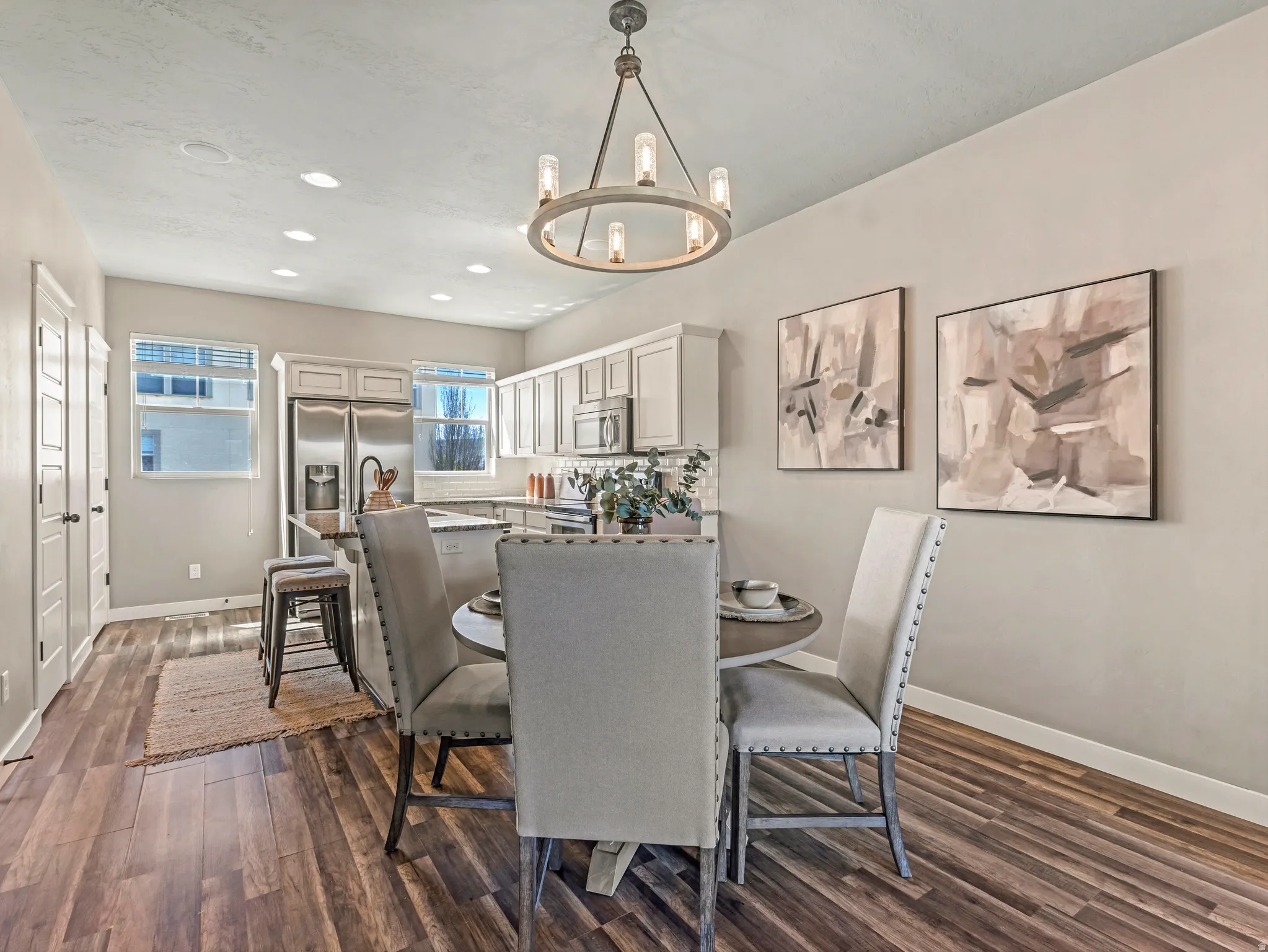 Dining space featuring dark wood-style flooring and hanging lights