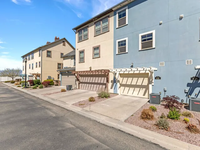 View of property featuring an attached garage and driveway