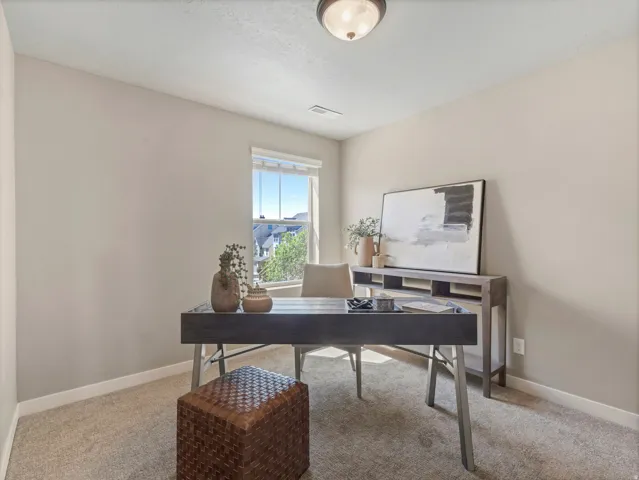 Home office featuring light carpet