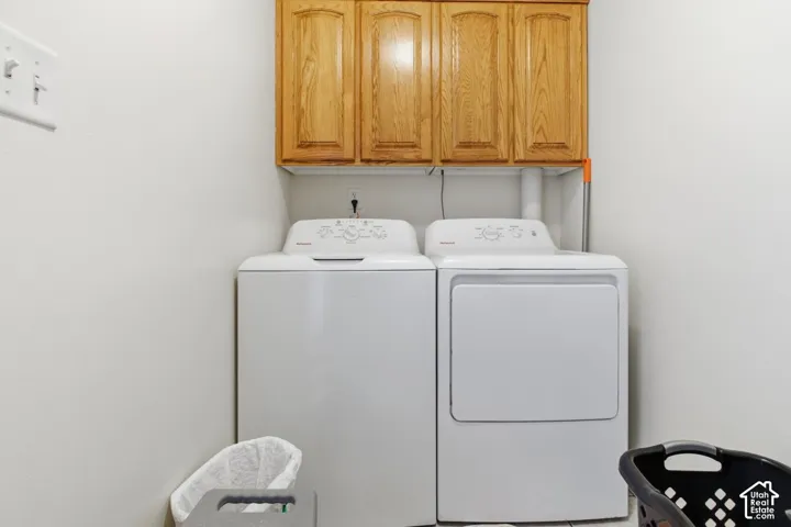 Laundry room with cabinet space and washer and clothes dryer
