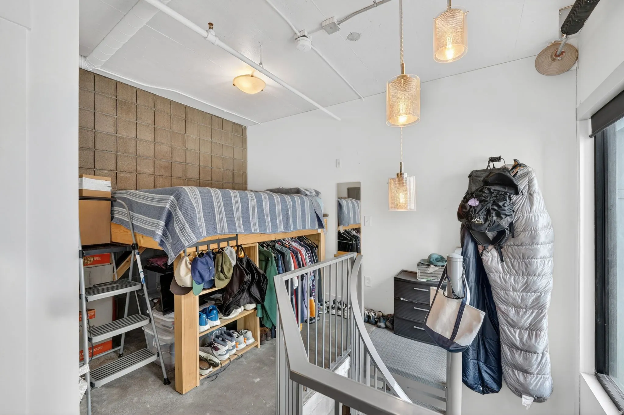 Bedroom featuring concrete floors and an accent wall
