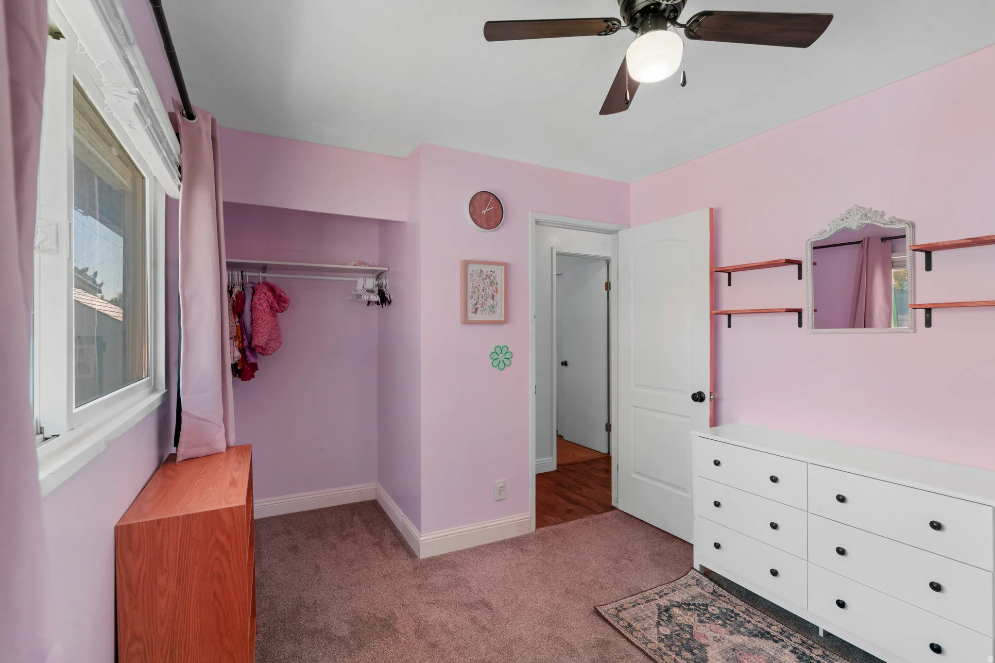 Unfurnished bedroom with light carpet, ceiling fan, and a closet
