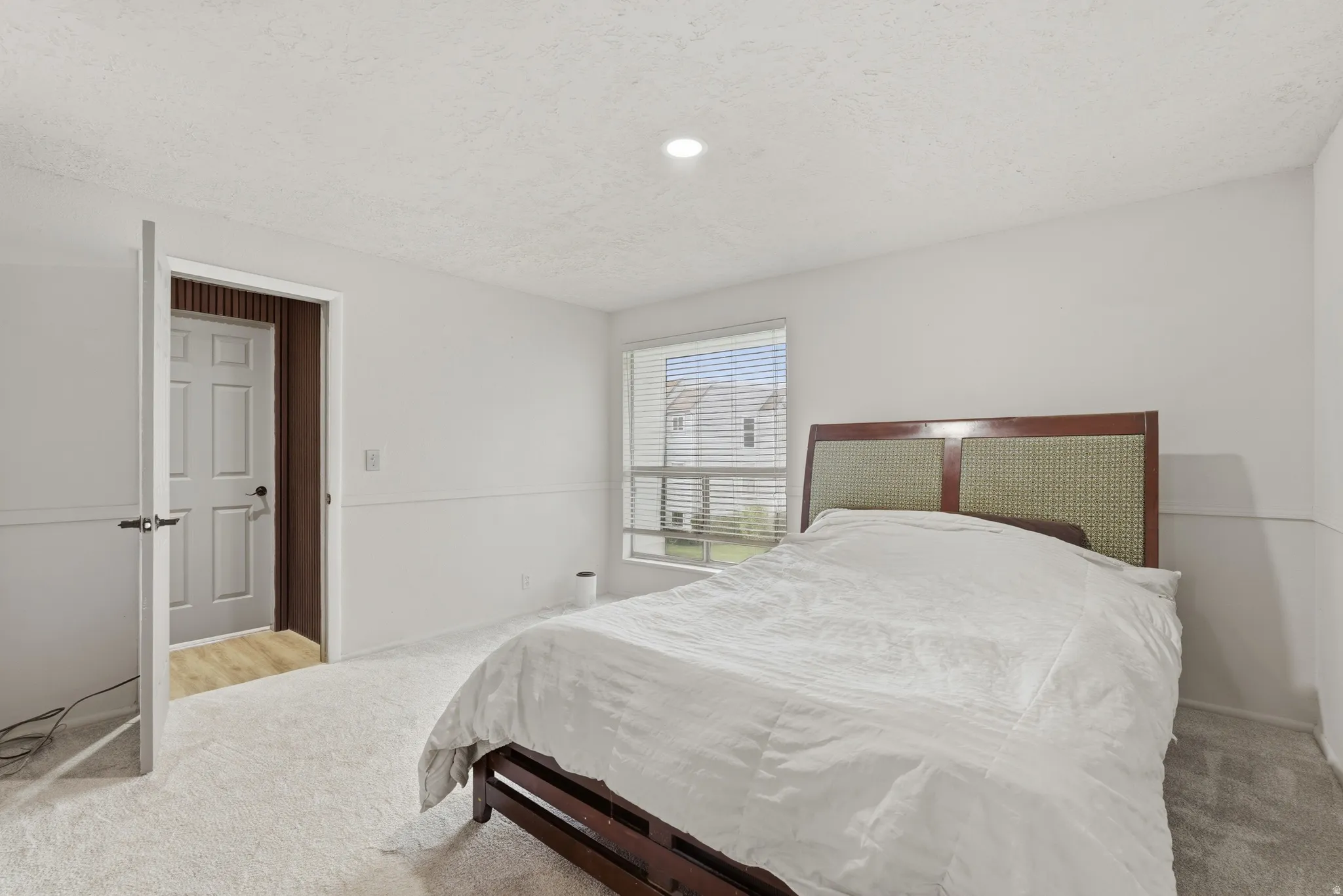 Bedroom featuring light colored carpet