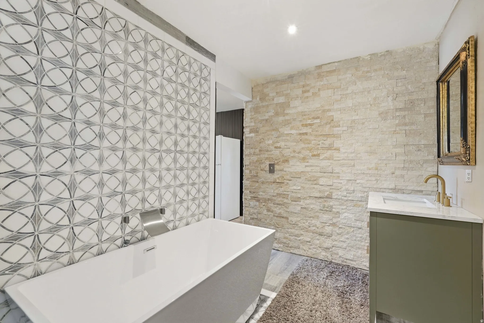 Full bathroom featuring vanity, a freestanding bath, and recessed lighting