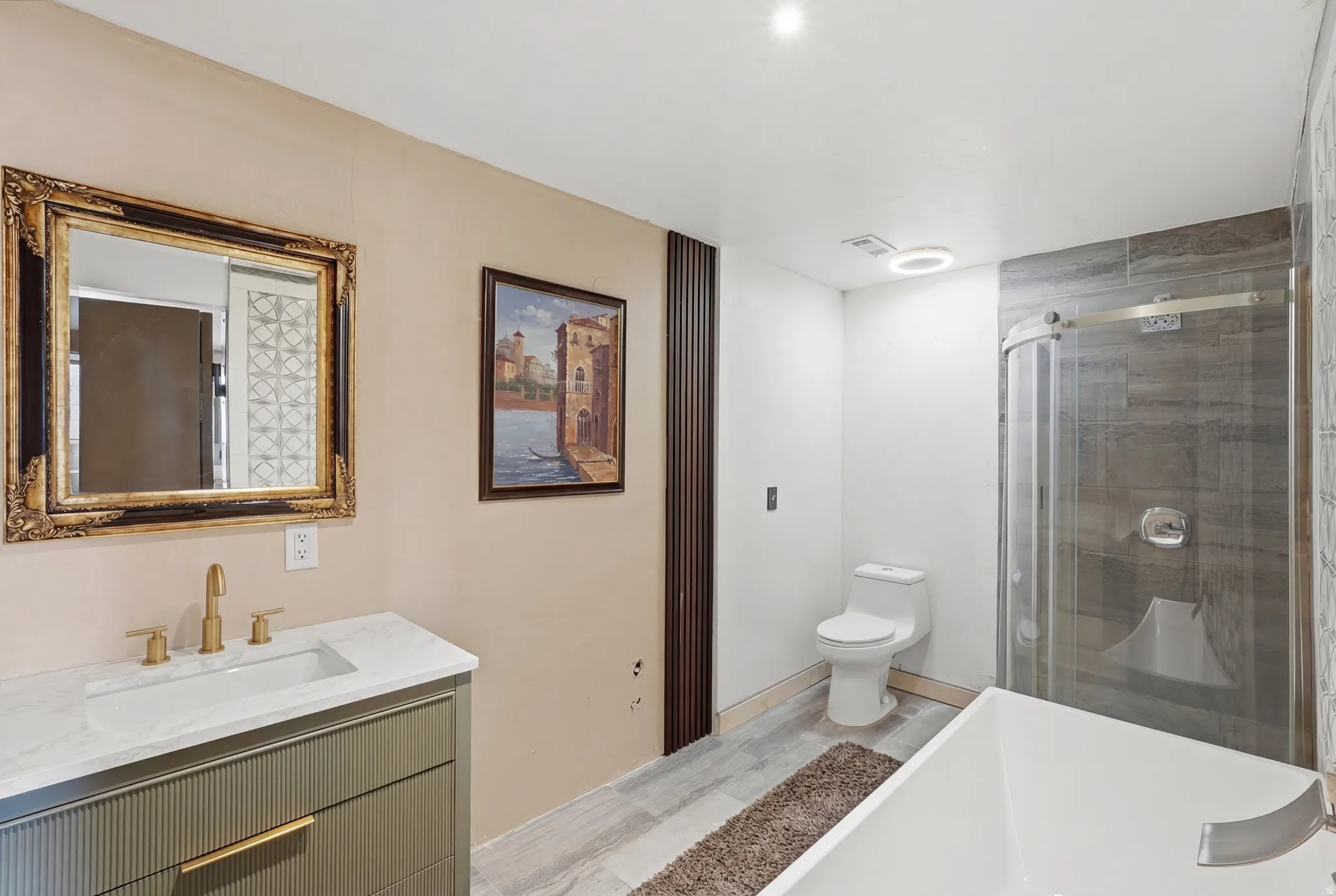 Full bath with vanity, a shower stall, and a freestanding bath