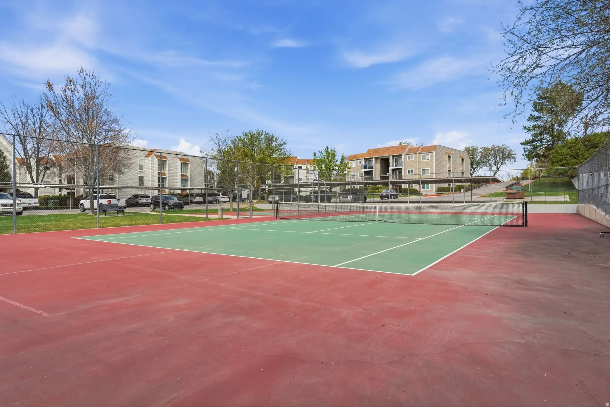 View of tennis court featuring a residential view