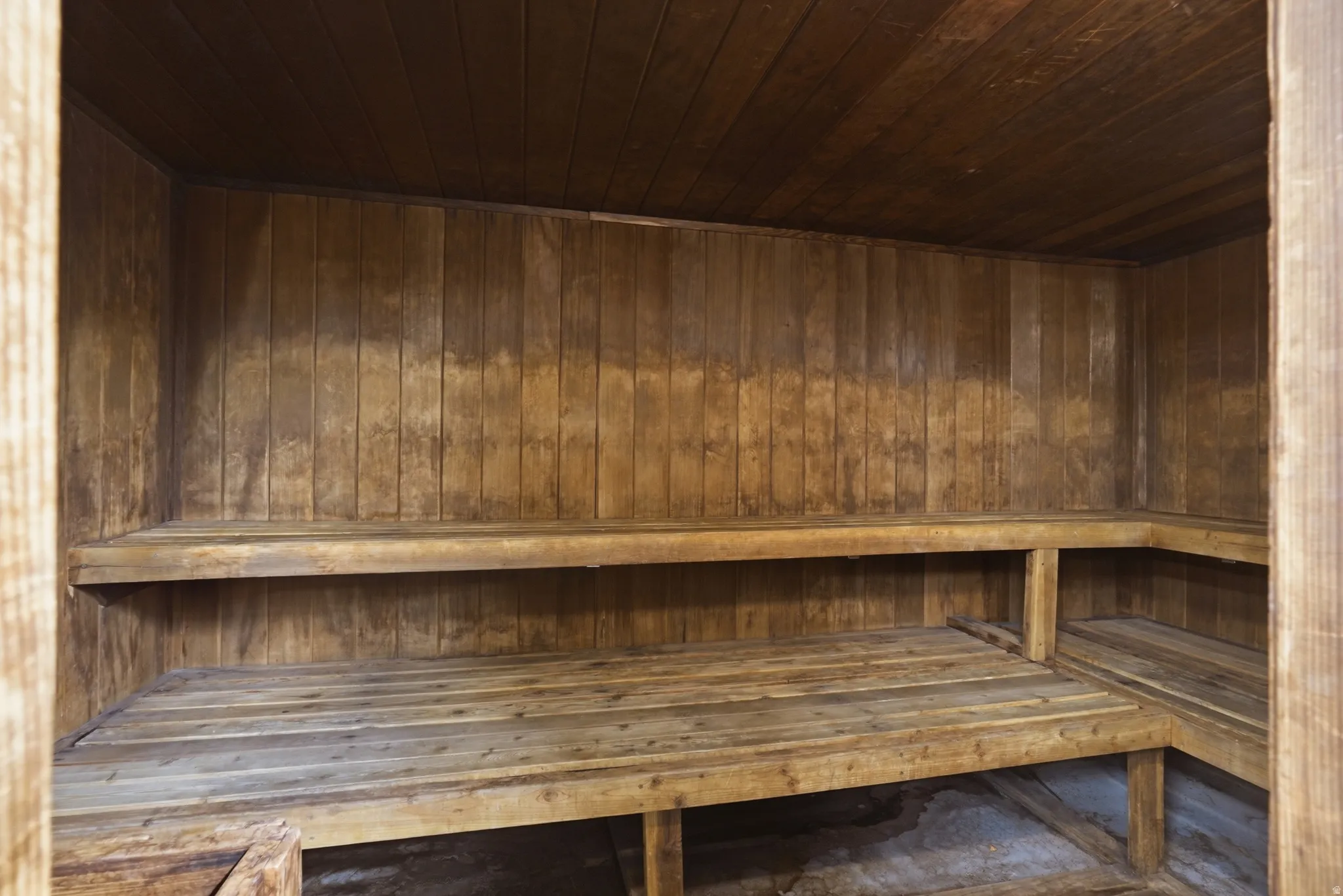 Relaxing sauna / steam room featuring wood ceiling and wooden walls