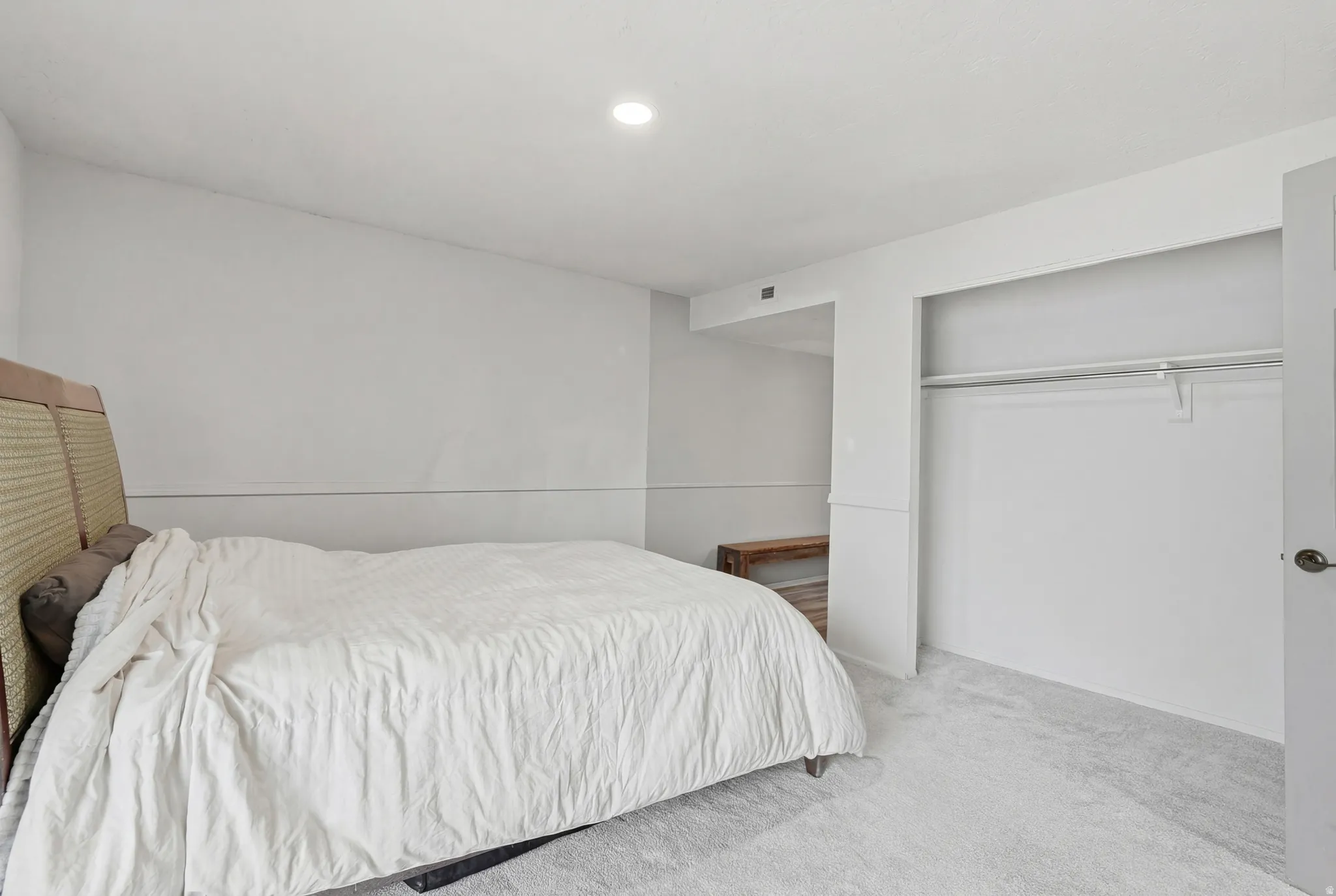 Carpeted bedroom with a closet