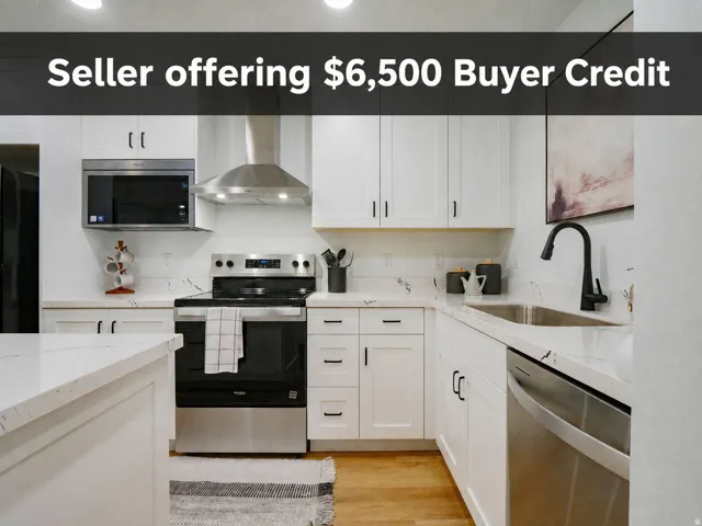 White cabinetry with dark hardware, stainless steel appliances, light-toned countertops, undermount sink with a matte black faucet, and wood-finish flooring