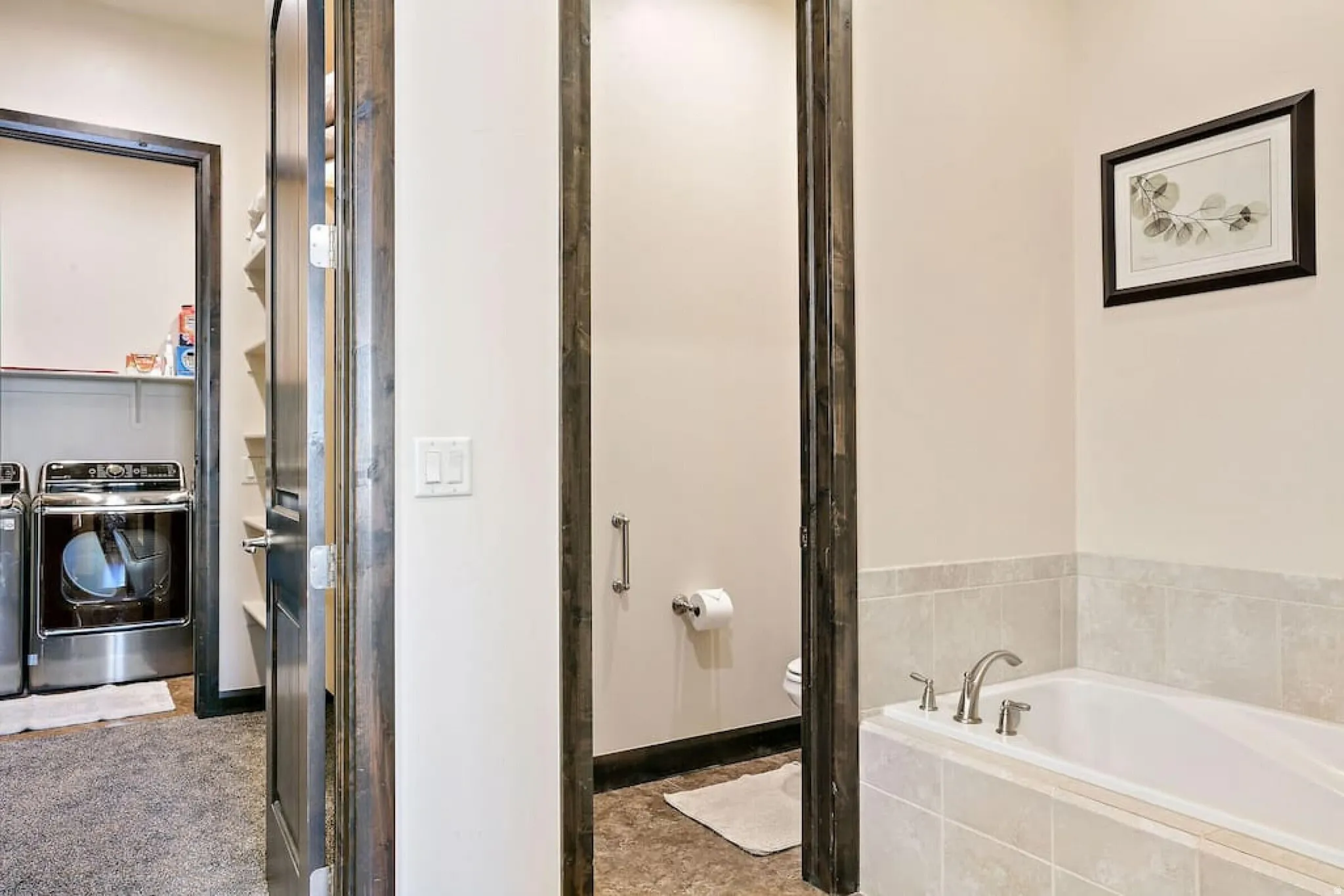 Bathroom featuring a bath and washer and dryer