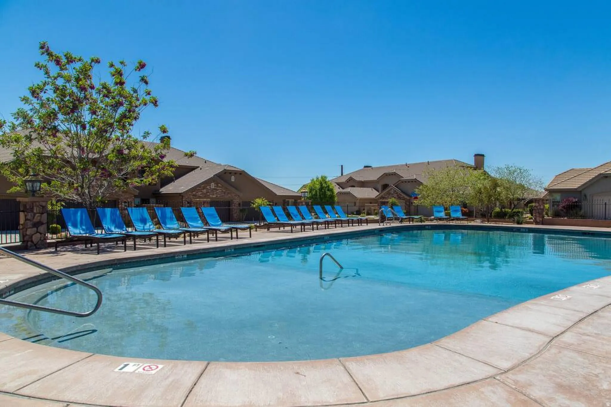 Community pool with a patio