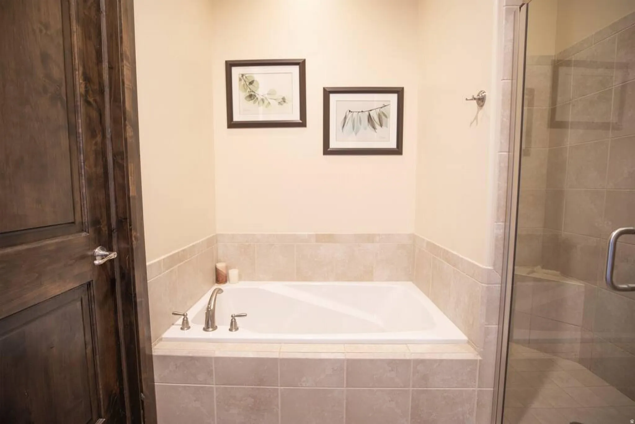 Bathroom featuring a shower stall and a bath