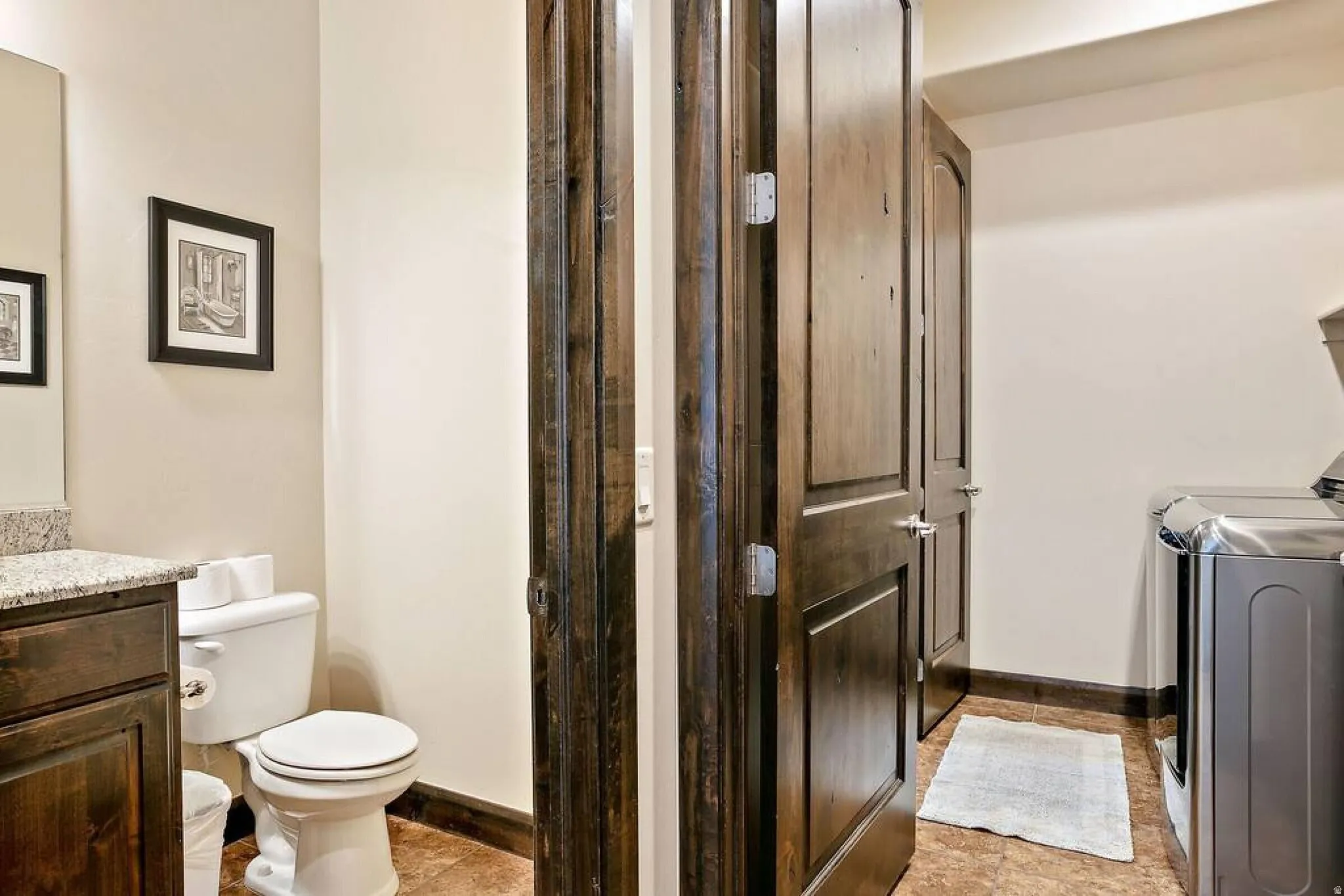 Bathroom featuring vanity and separate washer and dryer