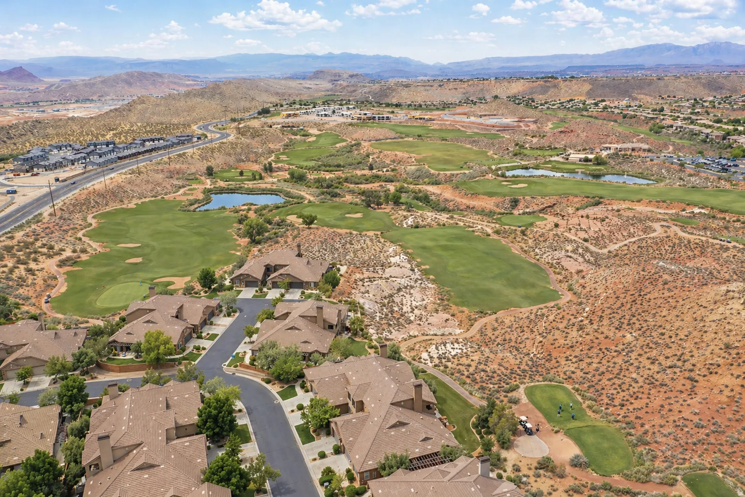 Aerial overview of property's location with a water and mountain view, a golf course, and nearby suburban area
