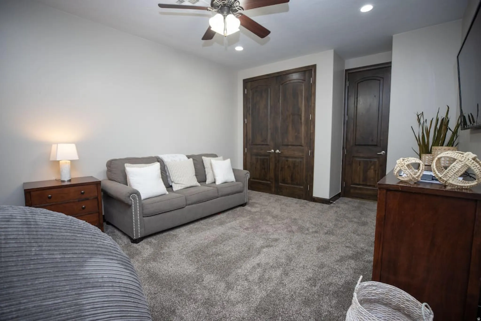 Carpeted bedroom with a closet, a ceiling fan, and recessed lighting