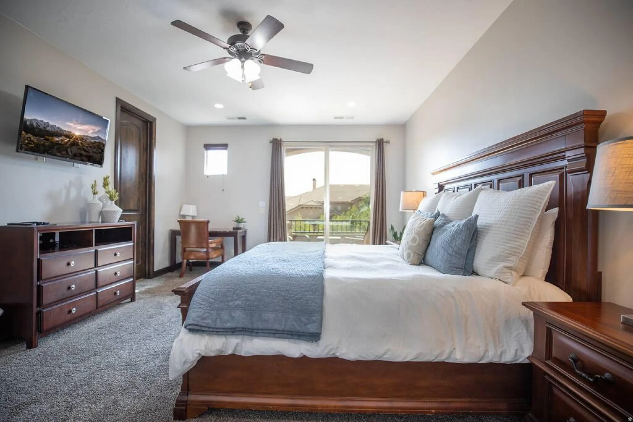 Bedroom with access to outside, ceiling fan, and dark carpet