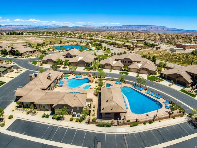 Community featuring two outdoor swimming pools, two hot tubs, and surrounding desert landscaping