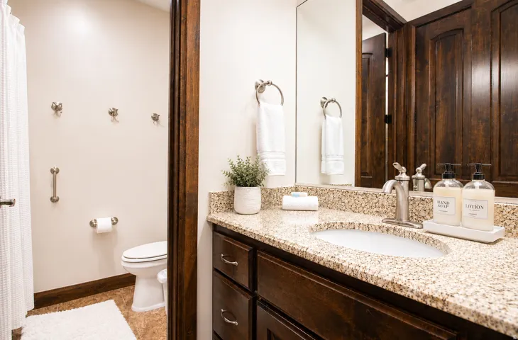 Vanity with a granite countertop and an undermount sink