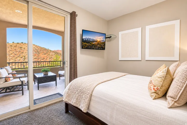 Sliding glass door opening to a private balcony with metal railing