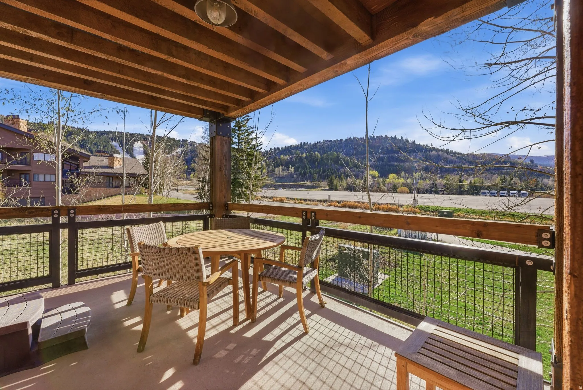 Wooden terrace featuring a mountain view and outdoor dining area