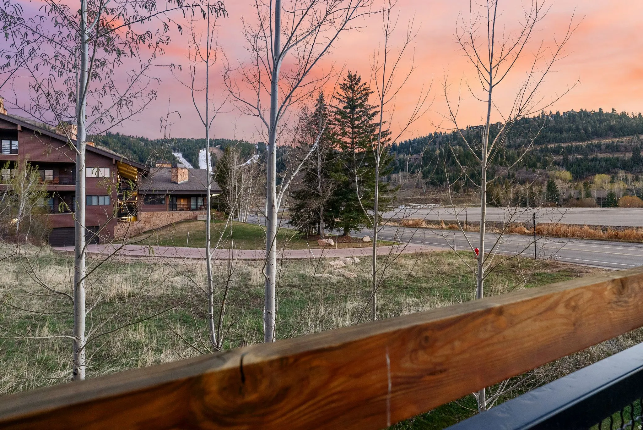 Yard at dusk featuring a balcony