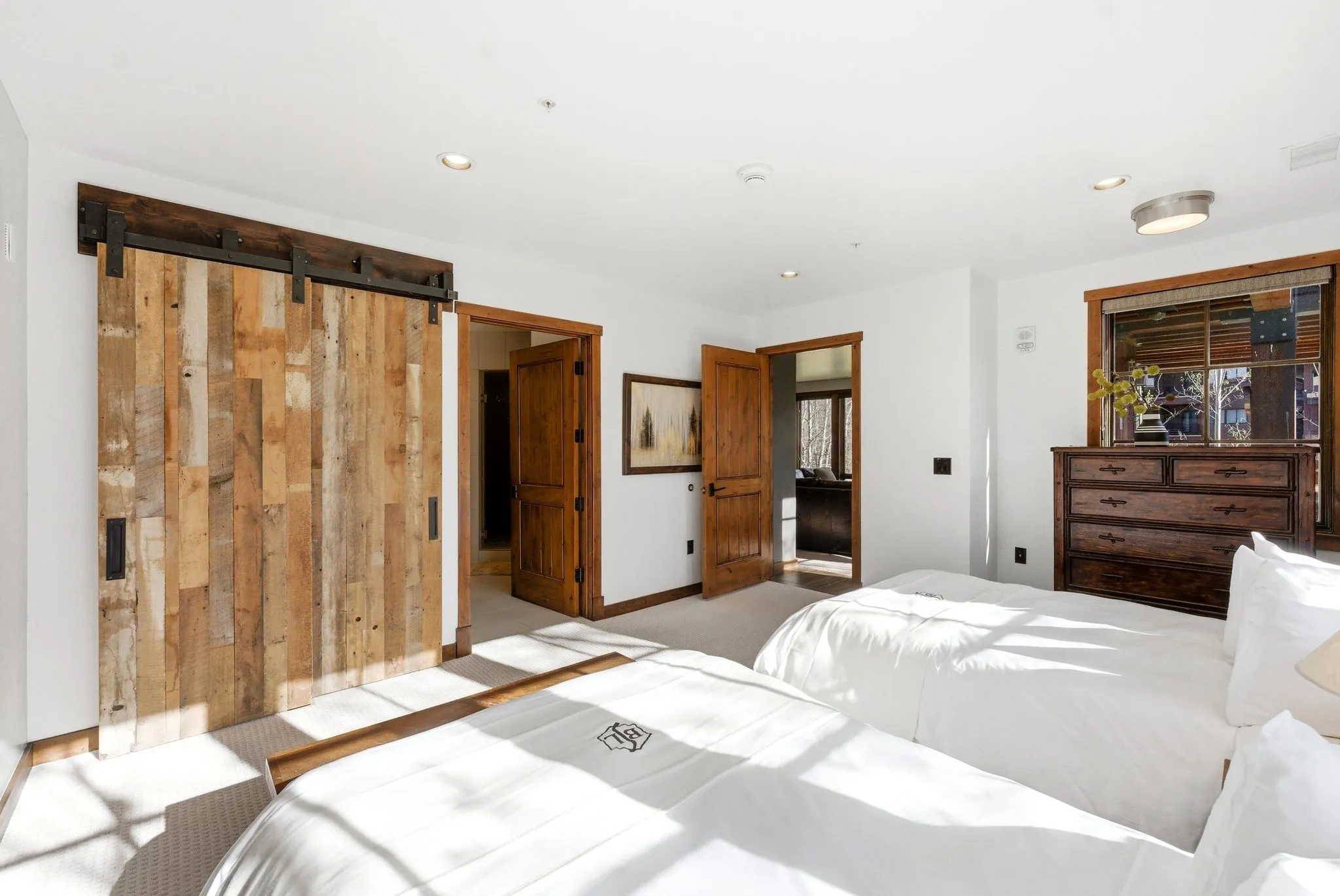 Bedroom featuring a barn door and recessed lighting