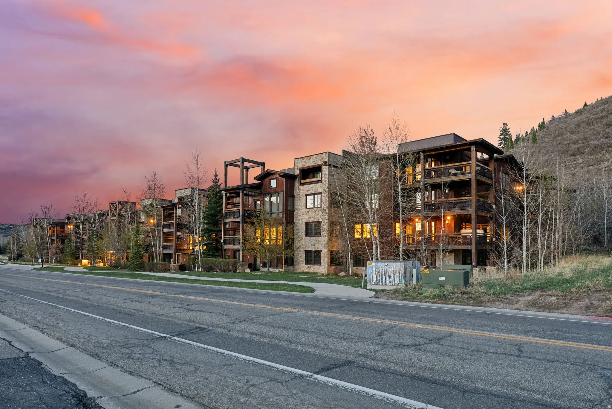 Property at dusk featuring a view of apartment building / complex