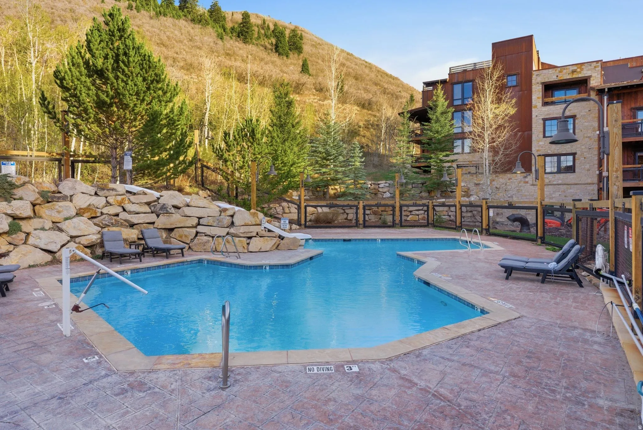 Community pool featuring a patio and a mountain view