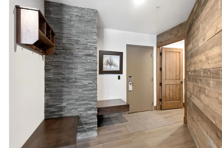 Mudroom featuring wood tiled floors and wooden walls