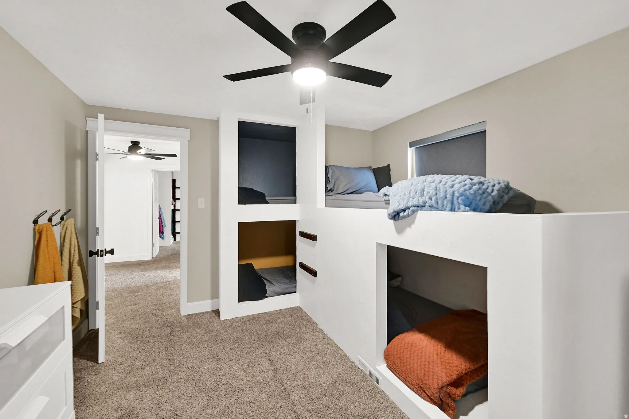 Bedroom featuring light colored carpet and a ceiling fan