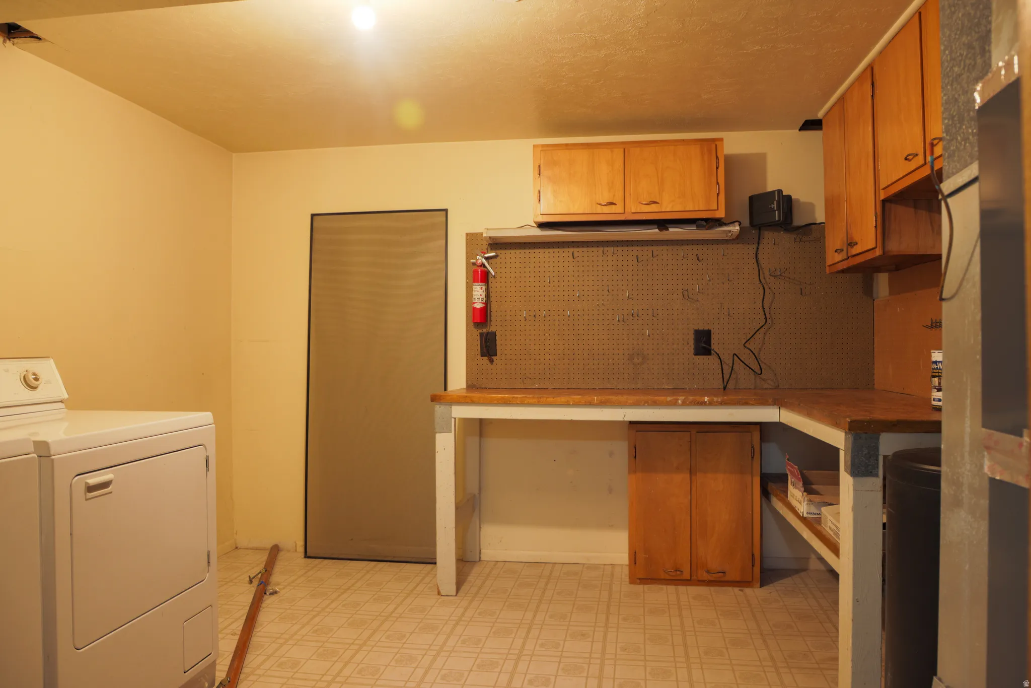 Laundry area featuring light flooring and washer / clothes dryer